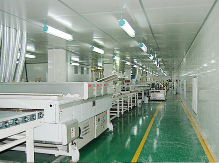 A modern workshop with rows of machinery where workers operate and monitor for customized and innovative production.