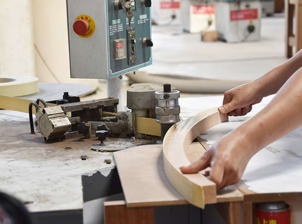 A worker operating a machine with a circular component, ensuring precision in the process.