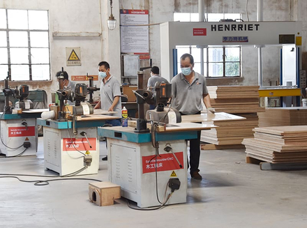 Workers operating machinery to process wood for innovative and customized products.