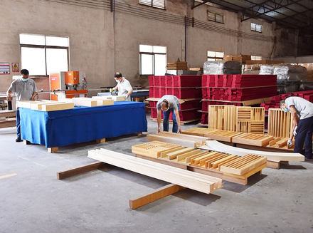 A worker is manually handling wooden pieces, possibly carving or fine - sanding, reflecting high - level manual craftsmanship.