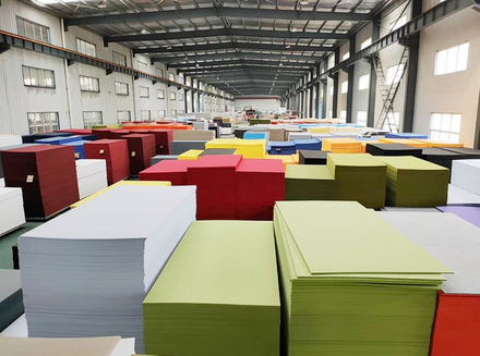 Processed wooden pieces are stacked in the workshop, with workers inspecting and organizing them, indicating attention to product quality.